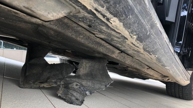 The damage underneath the car after driving over the exposed manhole. Picture: Supplied