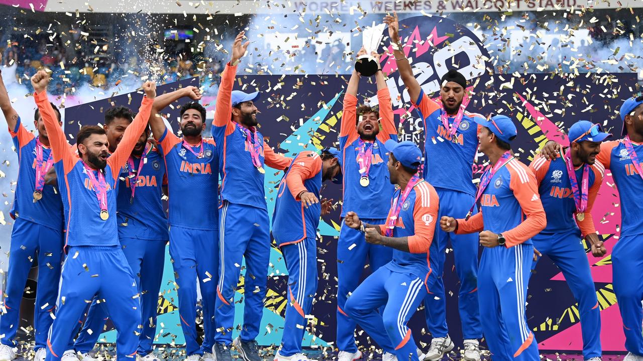 Kuldeep Yadav of India lifts the ICC Men's T20 Cricket World Cup Trophy. Photo by Gareth Copley/Getty Images.