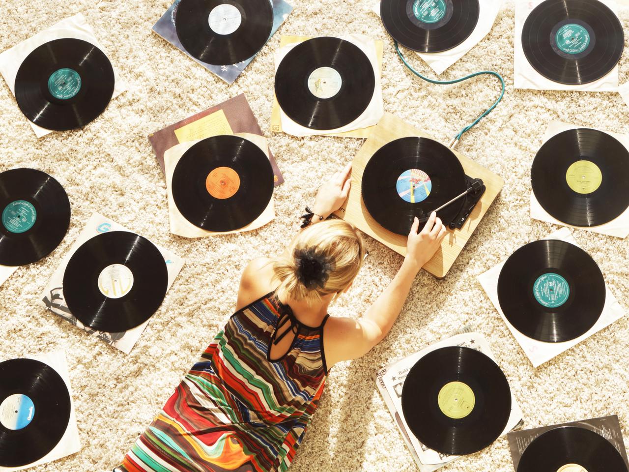 Woman on floor playing records