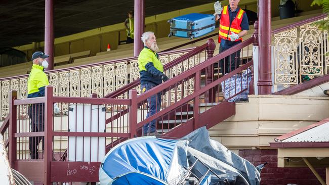 A suitcase is tossed into the bin. Picture: Jake Nowakowski