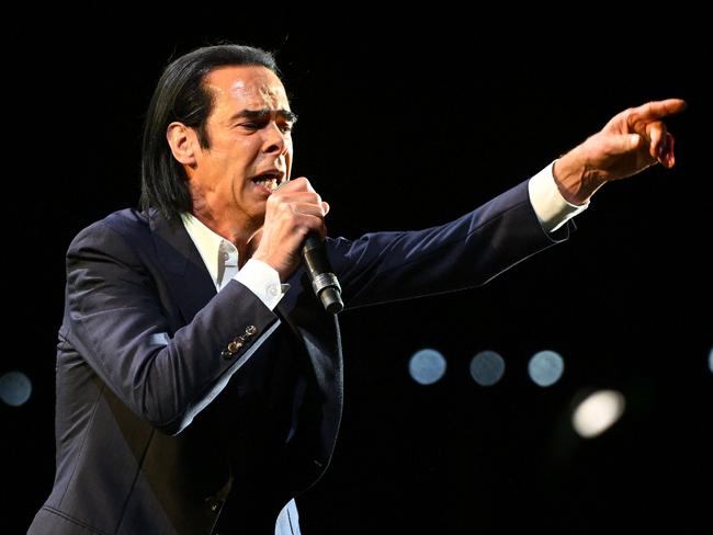 (FILES) In this file photo taken on August 25, 2022 Australian rock band Nick Cave and the Bad Seeds perfoms on stage during the 18th edition of the Rock en Seine music festival in Saint-Cloud, on the western outskirts of Paris. - Australian musician and artist Nick Cave said October 27, 2022 that Kanye West's repeated anti-Semitic comments were "shameful" but that his music transcends "the worst traits of his character." "It's a personal choice whether or not to listen to someone with controversial views," he said during a Q&A session at the London Literature Festival at the Southbank Centre, on the occasion of the release of a book of interviews with Sean O'Hagan, "Faith, hope and carnage." (Photo by Anna KURTH / AFP) / RESTRICTED TO EDITORIAL USE