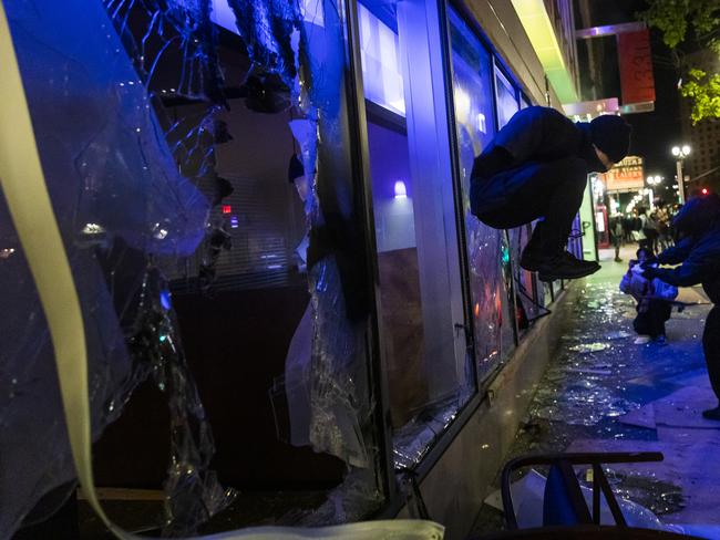 Protesters smash the window of a Chase bank during protests against the police shooting of George Floyd in Oakland, Califorina. Picture: AP