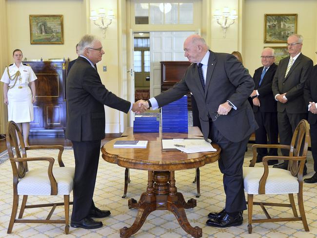 Commissioner Justice Peter McClellan (left) shakes hands with Governor-General Peter Cosgrove at the release of the report. Picture: Jeremy Piper/Australian Government Royal Commission via AP