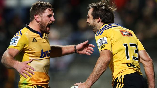 NEW PLYMOUTH, NEW ZEALAND - JUNE 13: Conrad Smith of the Hurricanes celebrates his try with teammate Callum Gibbins during the round 18 Super Rugby match between the Chiefs and the Hurricanes at Yarrow Stadium on June 13, 2015 in New Plymouth, New Zealand. (Photo by Hagen Hopkins/Getty Images)