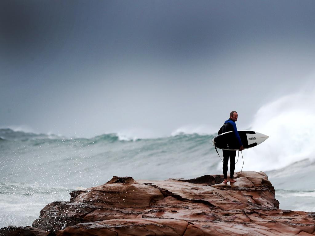 Surfers off Avoca Point as East Coast low hits Tuesday 4th June 2019 (AAP Image/Sue Graham)