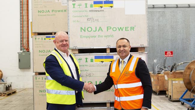 NOJA Power chief executive Neil O'Sullivan and Ambassador of Ukraine to Australia, Vasyl Myroshnychenko, at the loading of the Australian-made electrical equipment.