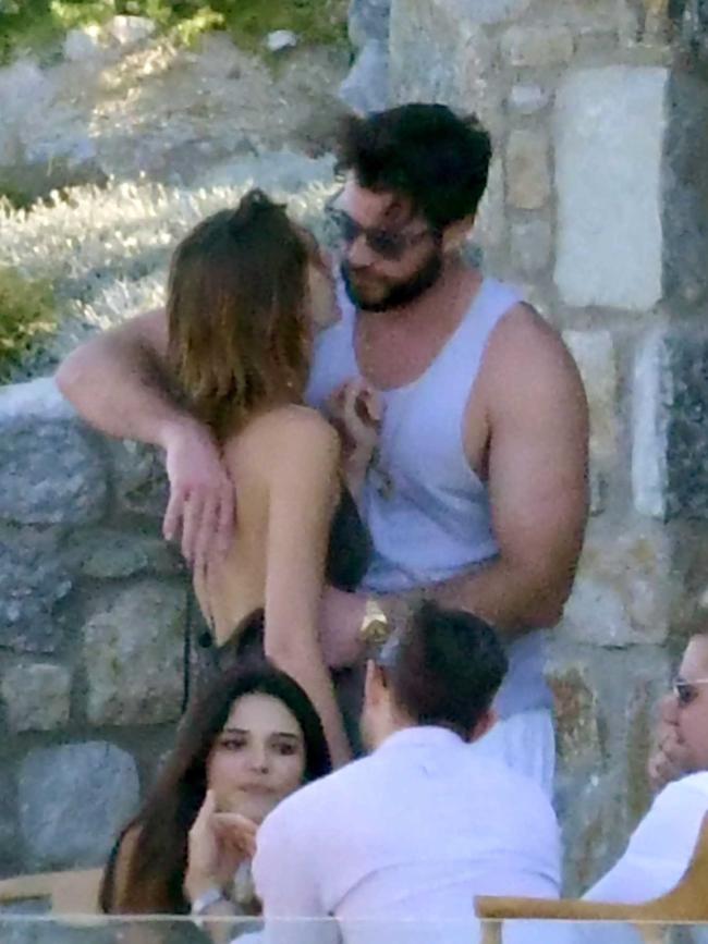 Liam Hemsworth and girlfriend Gabriella Brooks share a kiss poolside. Picture: Backgrid