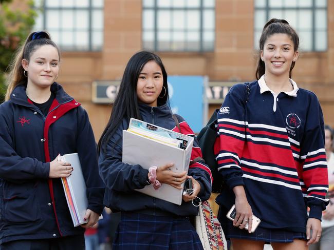 Newtown High School of the Performing Arts students Bella Olivares, 17, Rainbow Yang, 16, and Ashleigh Sturgeon, 16, at Central Station. Picture: Jonathan Ng