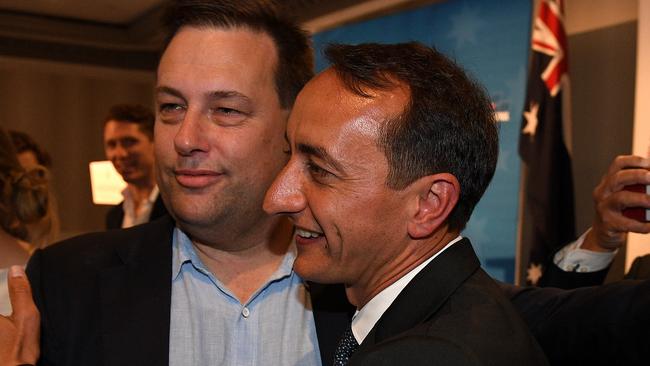 Liberal candidate Dave Sharma is embraced by Liberal MP Jason Falinski (left) after delivering his concession speech. Picture: AAP