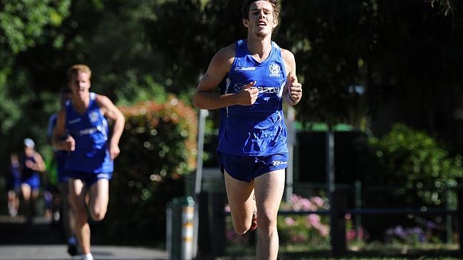  North Melbourne players hit the track with training at Princes Park.