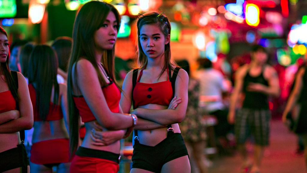 Two Thai women working at a bar in the red light district in Bangkok, a pop...