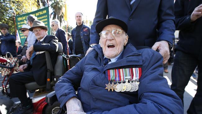 WWII navy veteran Ron Kimpton, 96, waits in the fenced staging area before the march. Picture: David Caird