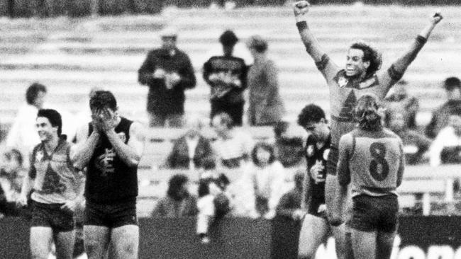 Brisbane Bears star Warwick Capper jumps for joy as his goal sinks Carlton.