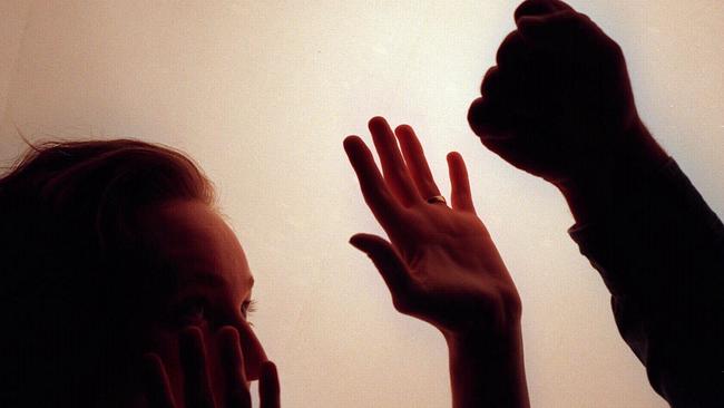 Domestic violence silhouette generic image - fist raised against woman./Violence