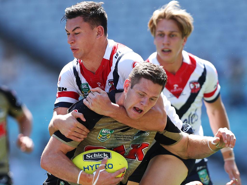 Penrith's Corey Waddell is tackled by Roosters’ Joseph Manu during the 2016 Holden Cup U20s Grand Final. Picture: Brett Costello