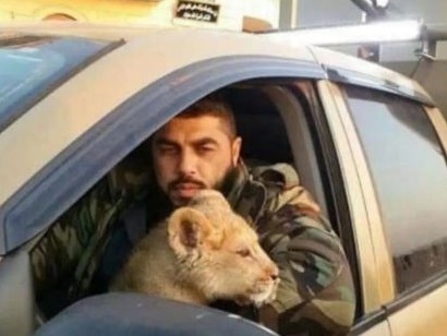 Talal Dakkak, with the lion he stole from a zoo, was a feared member of Syria’s infamous Tiger Forces. Picture: Supplied