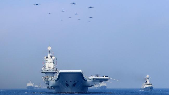 Chinese warships and fighter jets take part in a military display in the South China Sea. Picture: Reuters.