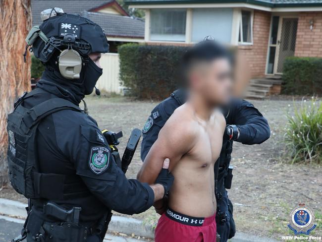 Police with 22-year-old Bradbury man Jaeden Tito in custody. Picture: NSW Police