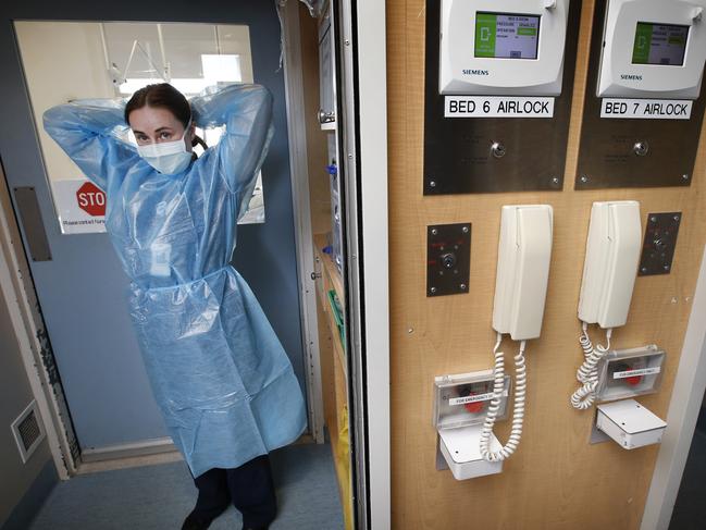 Royal Melbourne Hospital COVID-19 wards, ICU and Emergency wards readiness. Infectious Disease Ward RN Rosie Dickison puts on her PPE clothing before going into the sealed off room to attend to a COVID-19 patient that has just arrived.    Picture: David Caird