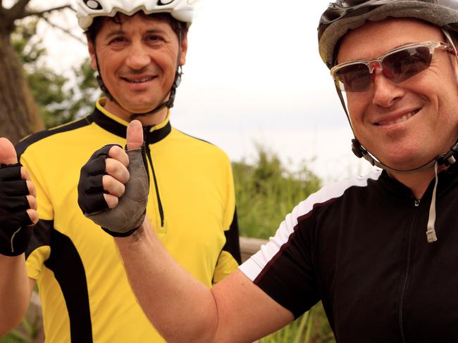 smiling cyclist with thumbs up