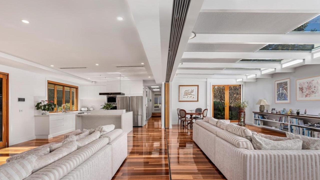 The soaring ceilings and expansive windows in the open-plan living zone flood the home with natural light and connect seamlessly to alfresco entertaining.