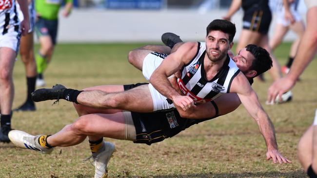 PNU’s Anthony Giannini is tackled by Brighton’s Tarquin Brown during the Bomers’ win on Saturday. Picture: Keryn Stevens