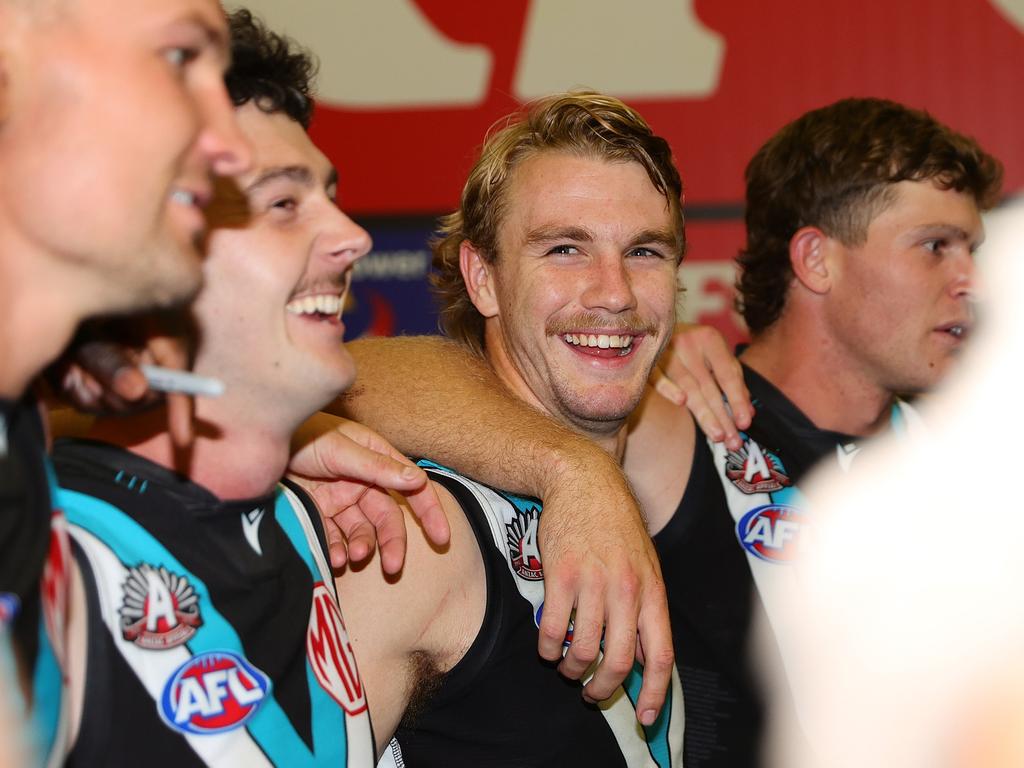 Jason Horne-Francis smiling in the rooms after Saturday’s win. Picture: Sarah Reed/AFL Photos via Getty Images.