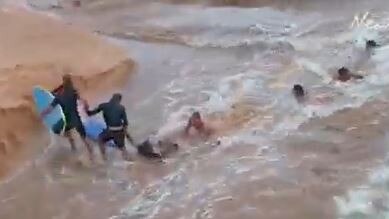 Surfers and beachgoers rescue a man swept away by the powerful current as water rushed from the entrance to Dee Why Lagoon into the ocean in February. Image: Instagram – skymonkey5.