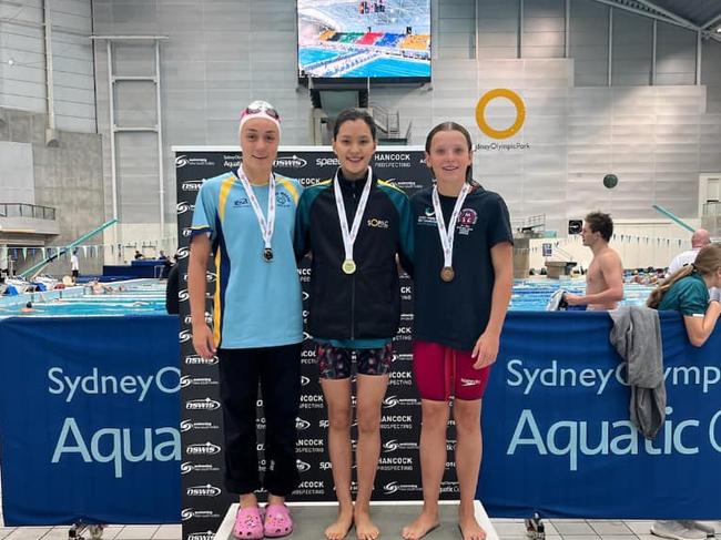 SOPAC's Heidi Shumack claims gold by a narrow margin over Wagga Wagga's Abbie Donelan. Photo from Wagga Wagga Swim Club Facebook.