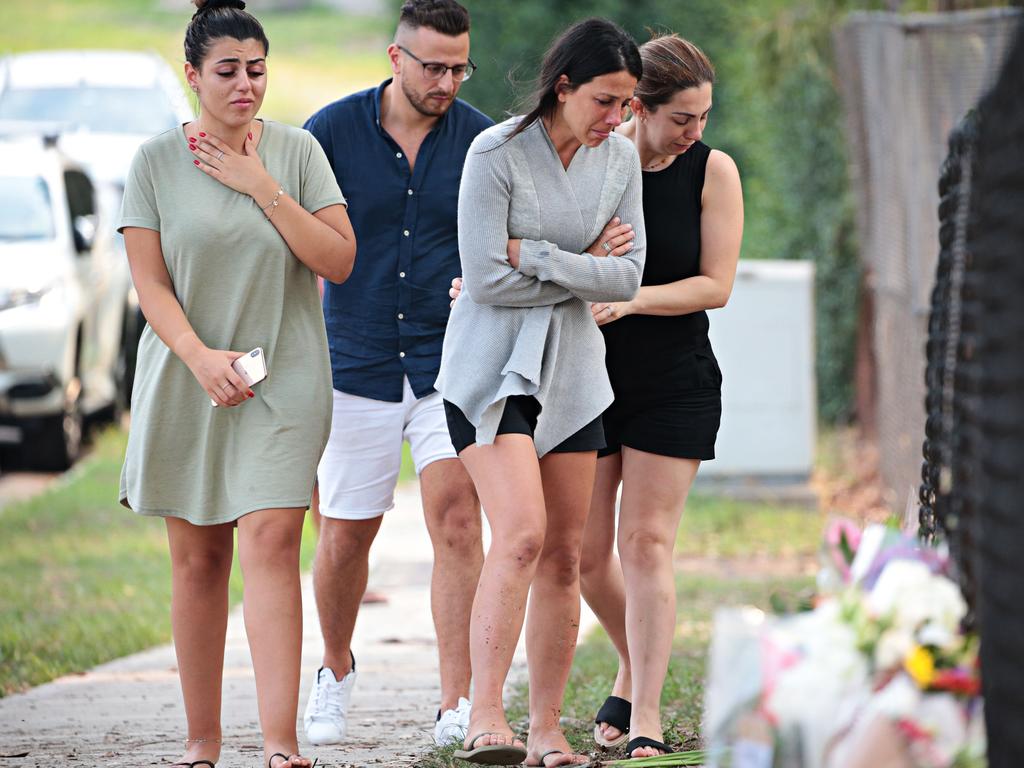 Leila Abdallah (grey cardigan) grieving at the site where three of her children where killed. Picture: Adam Yip