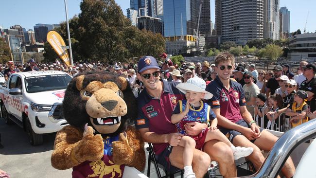 Fans young and old gathered to see their favourite players and coaches travel down utes in a motorcade starting at Melbourne Park. Picture: NCA NewsWire / David Crosling