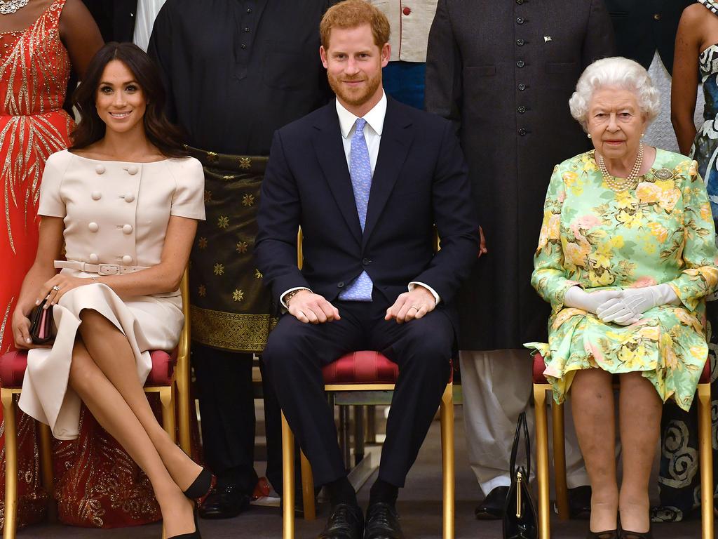 Megan crosses her legs during the Queen’s Young Leaders reception. Apparently a big no, no. Picture: Mega