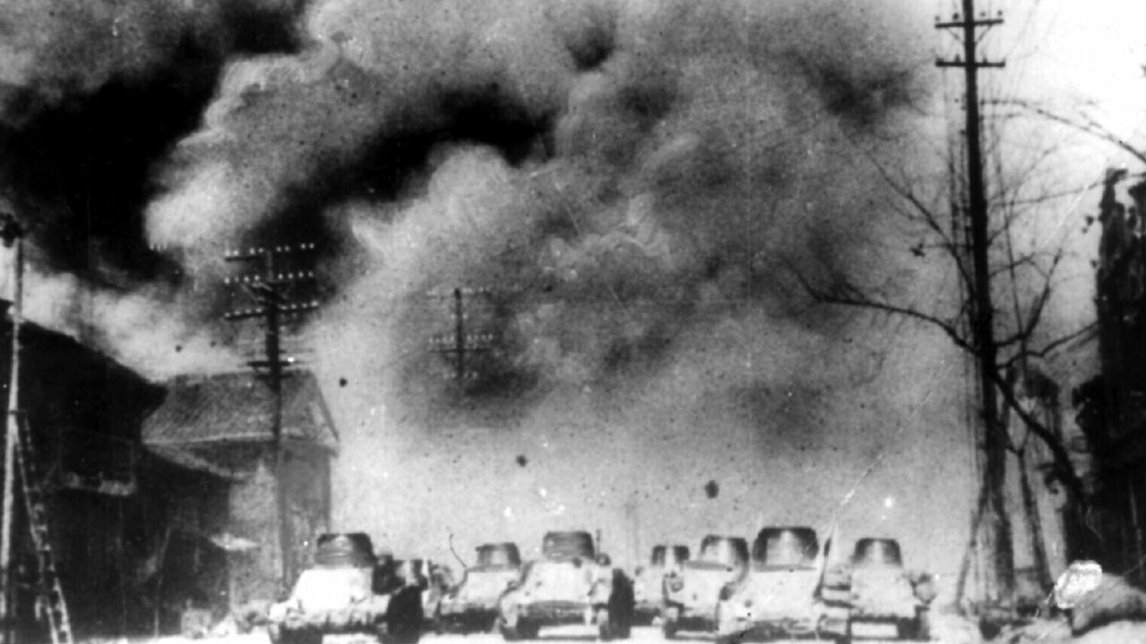 Japanese tanks thunder through Nanking suburb in China in December 1937. China