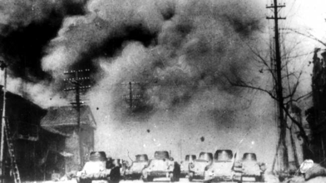 Japanese tanks thunder through Nanking suburb in China in December 1937. China