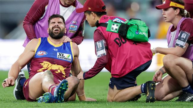 Lions medical staff assist Marcus Adams after he suffered a blow to the ribs in Brisbane’s win over Carlton. Picture: Russell Freeman / AFL Photos via Getty Images