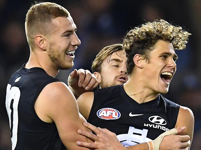 MELBOURNE, AUSTRALIA - JUNE 15: Charlie Curnow of the Blues is congratulated by team mates after kicking a goal during the round 13 AFL match between the Carlton Blues and the Western Bulldogs at Marvel Stadium on June 15, 2019 in Melbourne, Australia. (Photo by Quinn Rooney/Getty Images)