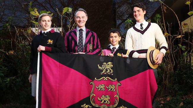 Harry Opray 16 in year 10, Rob McEwan Headmaster, Jonni Marino 11 in grade 5, Harry Jones 17 in year 12 with old Hutchins uniforms and the school flag. The Hutchins School are celebrating their 175th birthday. Picture: Nikki Davis-Jones