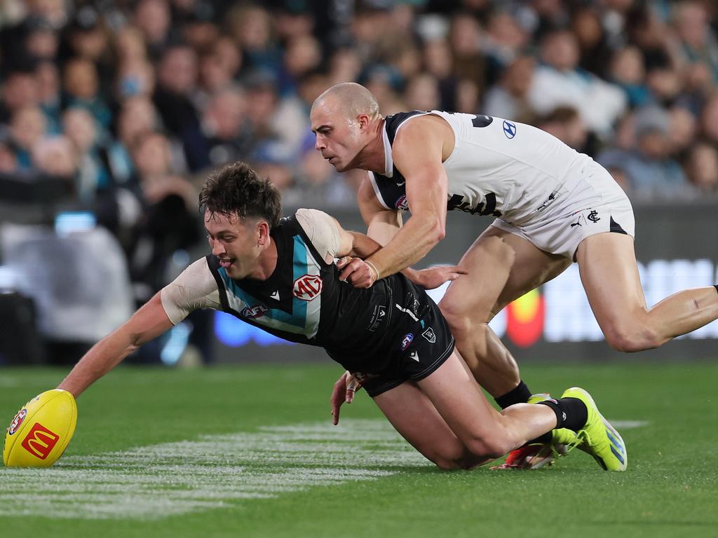 Alex Cincotta keeps a hold on Port Adelaide star Zak Butters. Picture: James Elsby/AFL Photos via Getty Images