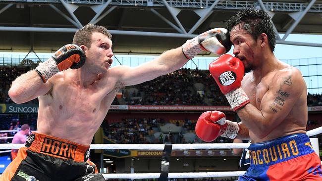 Manny Pacquiao of the Philippines (right) is struck by Jeff Horn.