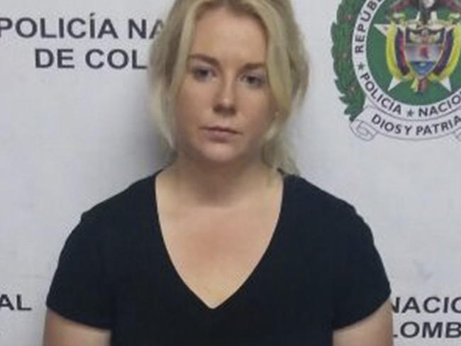 This April 12, 2017 photo released by Colombia's National Police press shows Australian Cassandra Sainsbury in handcuffs after she was arrested at the international airport in Bogota, Colombia. According to police, an x-ray machine detected almost six kilograms of cocaine hidden in packages stashed in her luggage as the 22-year-old was preparing to board a flight to London on her way back to Australia. (Colombia's National Police via AP)