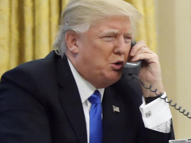 In this photo taken Jan. 28, 2017, President Donald Trump speaks on the phone with Australian Prime Minister Malcolm Turnbull in the Oval Office of the White House in Washington. Transcripts of President Donald Trumpâ€™s conversations with the leaders of Mexico and Australia in January offer new details on how the president parried with the leaders over the politics of the border wall and refugee policy, with random asides on subjects including drug abuse in New Hampshire. (AP Photo/Alex Brandon)