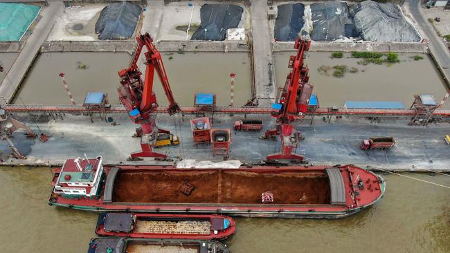 Cranes unloading imported mineral powder from a cargo ship at a port in Nantong in China's eastern Jiangsu province. Picture: AFP