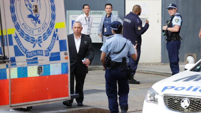 RPA staff and security talk to police at the scene on Tuesday. Picture: Christian Gilles