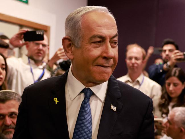 TOPSHOT - Israeli Prime Minister Benjamin Netanyahu arrives at the district court in Tel Aviv for his hearing on corruption charges on December 10, 2024. Netanyahu, the first sitting prime minister of Israel to face a criminal trial, testified for the first time when his corruption case resumed on December 10 on charges of bribery, fraud and breach of public trust in three separate cases. (Photo by Menahem KAHANA / POOL / AFP)