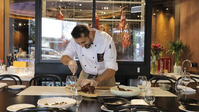 Chef Miki Damjanovic prepares a whole duck at The Duck Room at Bowen Hills. Picture:  Mark Cranitch.