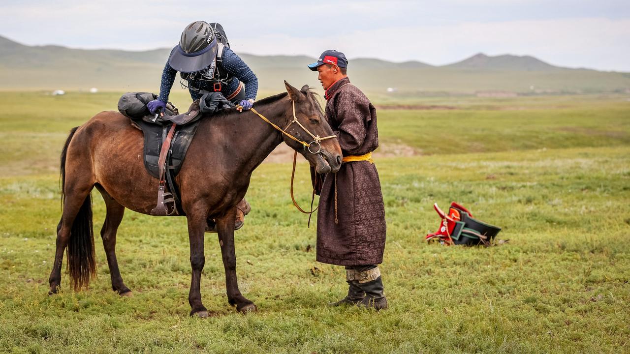 Warwick's Kelly Dudley mounts her horse during a stage of the 2024 Mongol Derby. (Pictures supplied by Kathy Gabriel and Tulgaa Skizz)