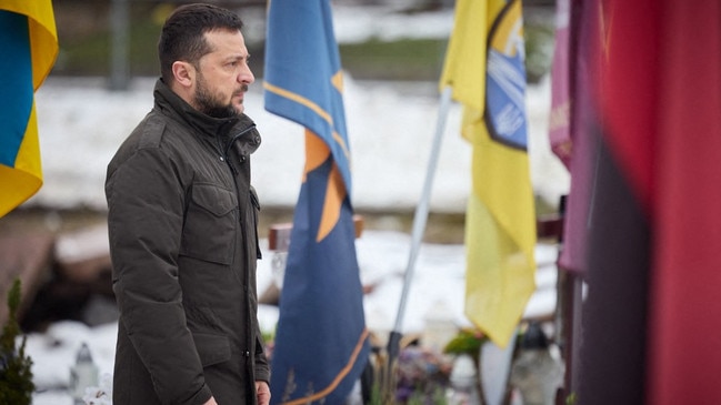 Ukrainian President Volodymyr Zelensky paying his respects at the graves of Ukrainian soldiers at the Lychakiv Cemetery in Lviv. Picture: AFP Photo/Ukrainian Presidential Press Service