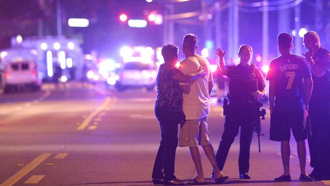 Police officers direct family members away from the Pulse nightclub in Orlando during the shooting by Omar Mateen that killed 49 people. Picture: AP/Phelan M. Ebenhack