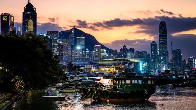 The sun sets behind Hong Kong's skyline on November 1, 2024. (Photo by Mladen ANTONOV / AFP)