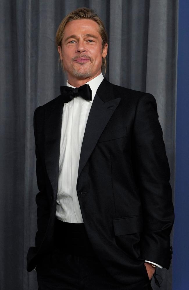 Last year’s Best Supporting Actor winner Brad Pitt suited up backstage at the Oscars. Picture: AFP